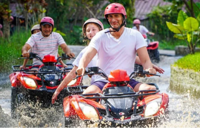 ATV quad bike splashing through water in Bali